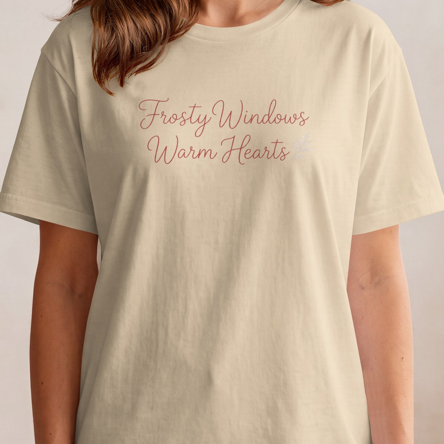 Cream t-shirt with "Frosty Windows Warm Hearts" text in a script font.