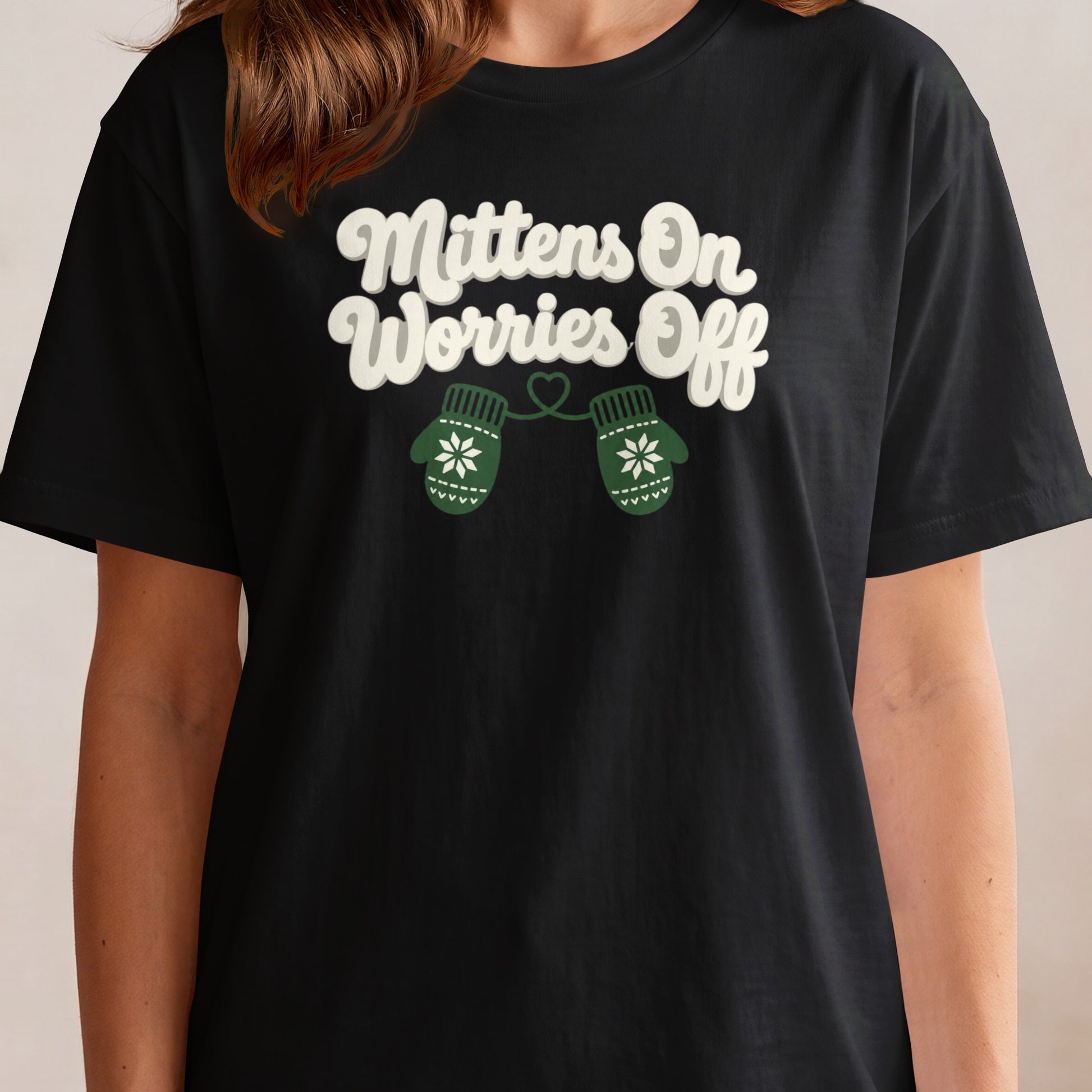 Black t-shirt with white text "Mittens On Worries Off" and green mittens.