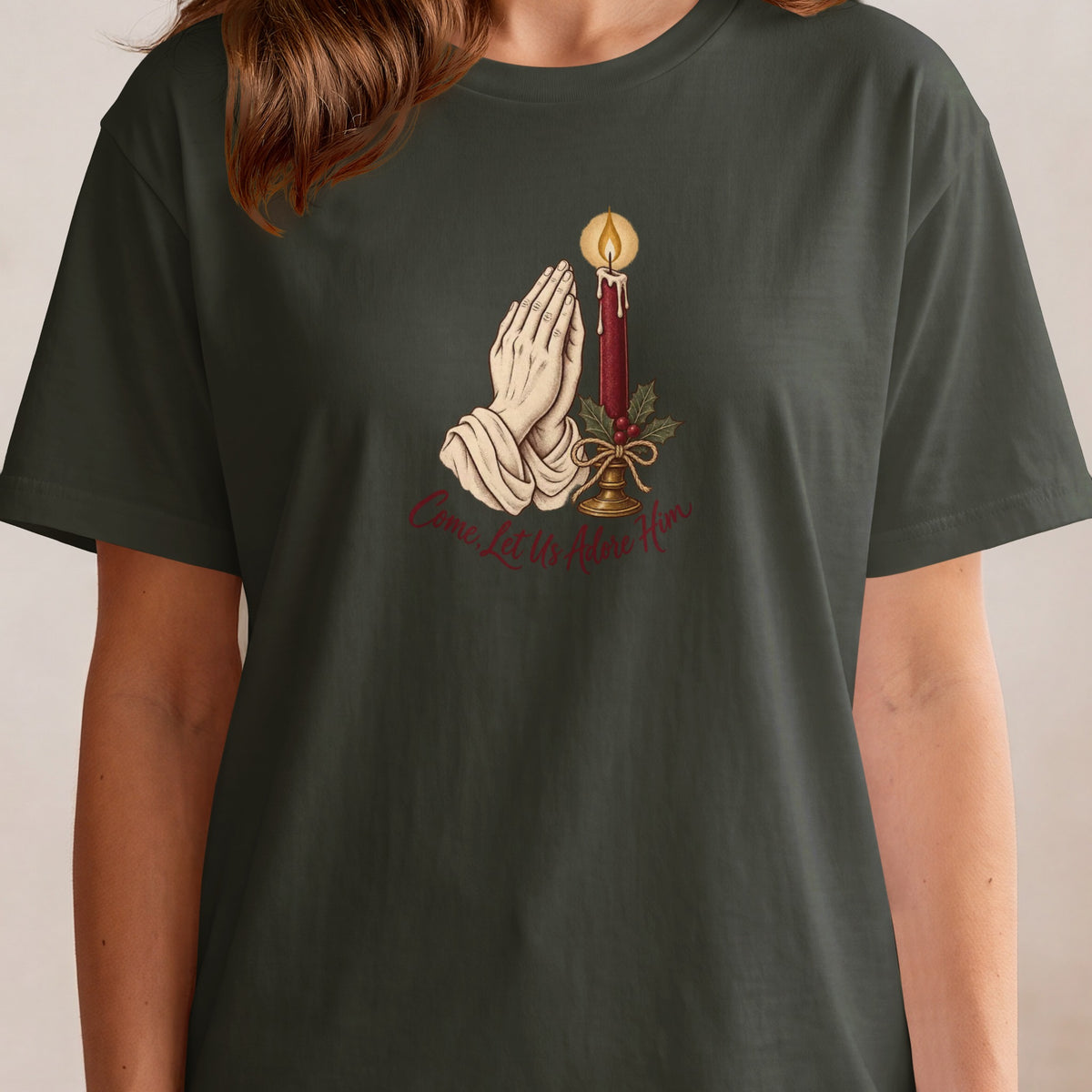 Dark t-shirt with a Christmas graphic of praying hands and a candle.