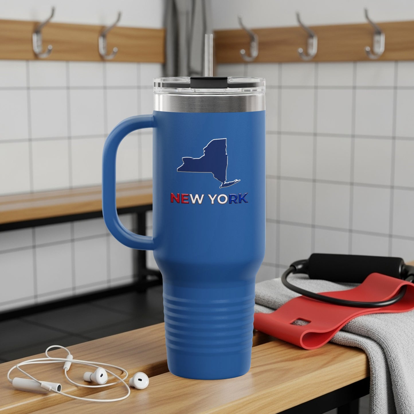 Blue tumbler with New York outline and text on locker room bench.