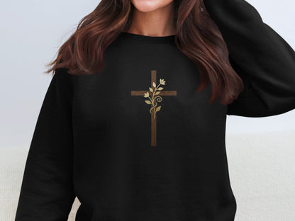 Black sweatshirt with a wooden cross and floral vine design.