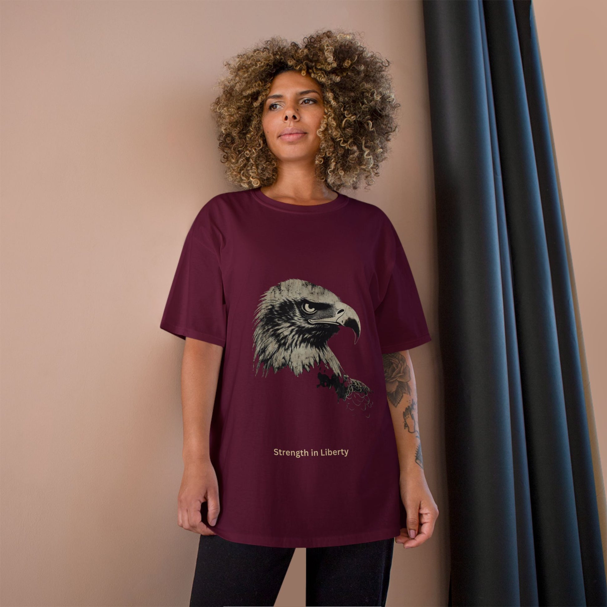 Strength in Liberty small font text below an eagle head on a Champion Tee