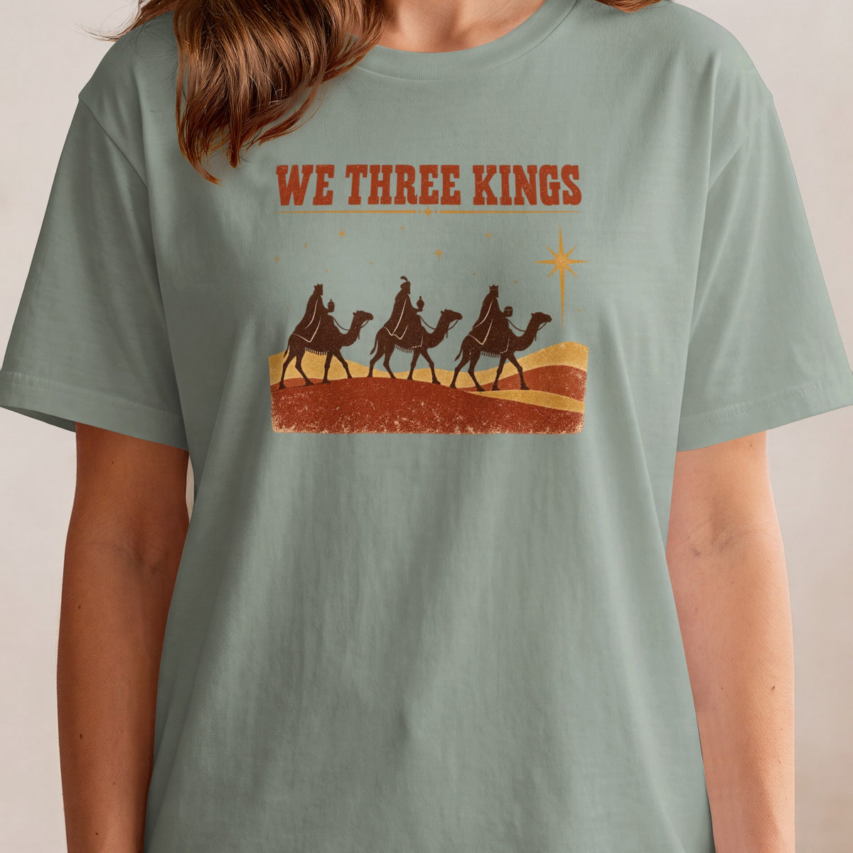 "We Three Kings" text above three kings riding camels with a star.
