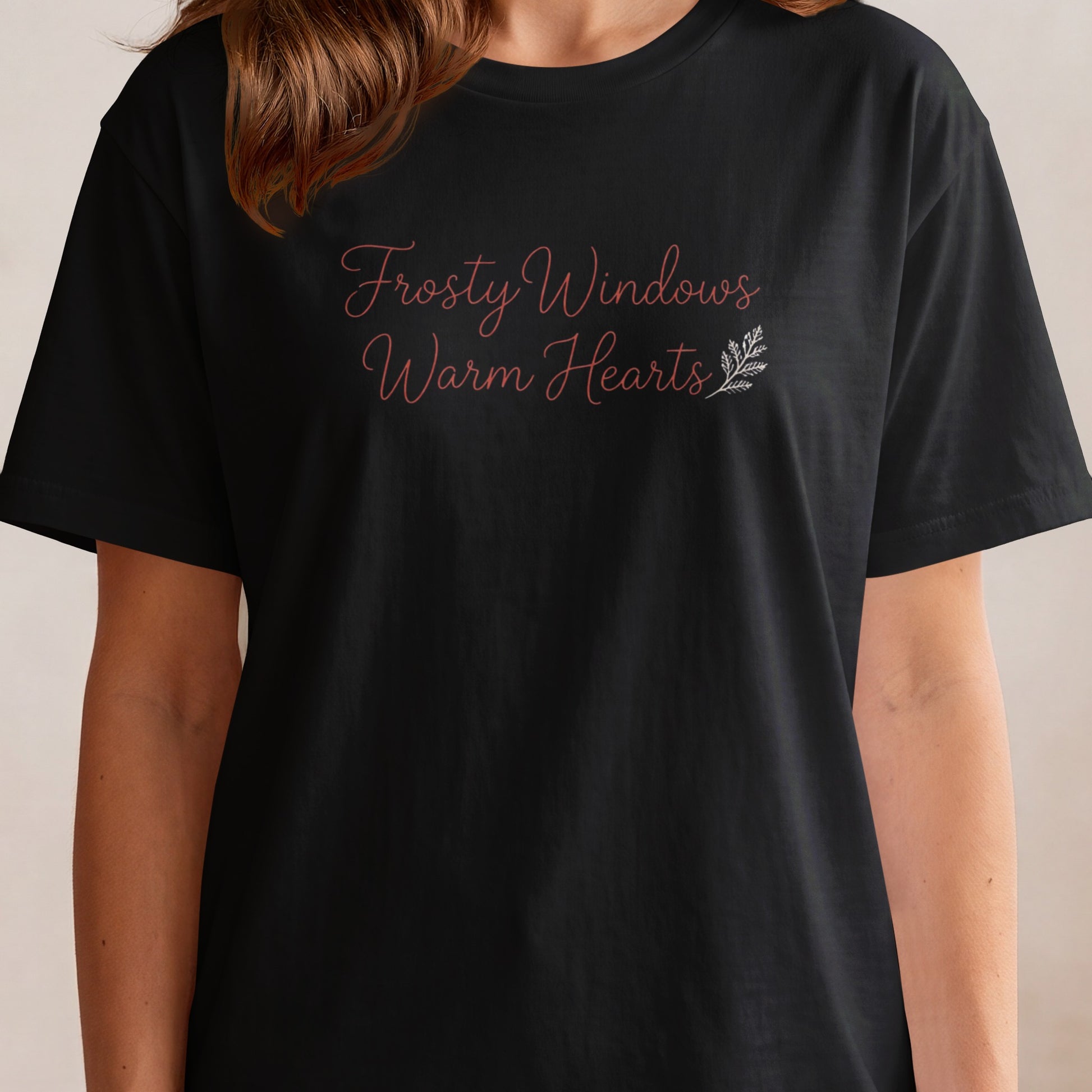 Black t-shirt with "Frosty Windows Warm Hearts" text and a small branch graphic.