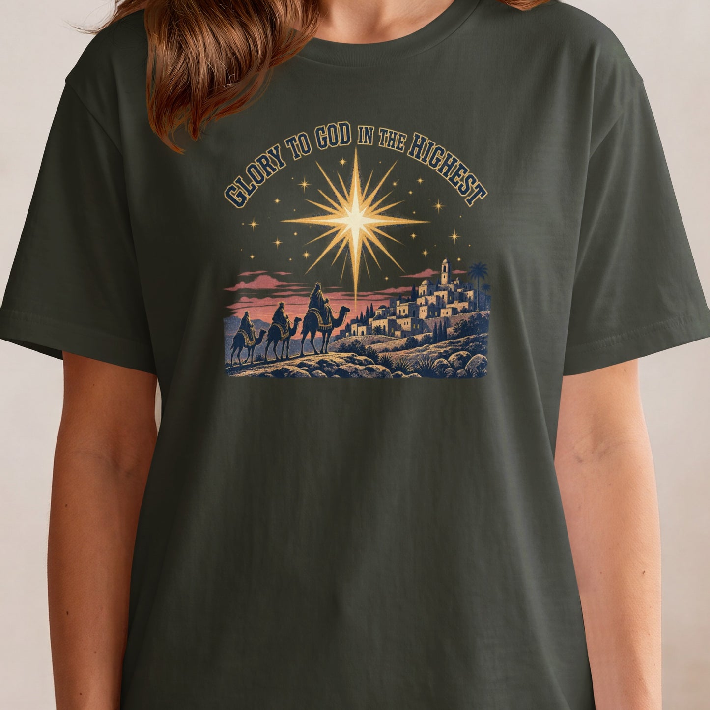 Nativity scene with three wise men on camels beneath a star and text "Glory to God in the Highest."