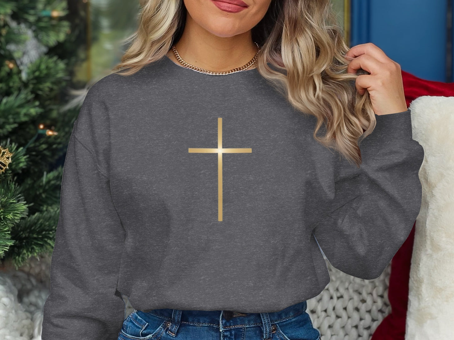 Dark grey sweatshirt with a gold cross graphic.
