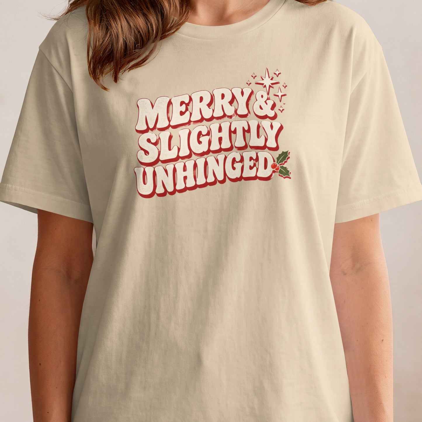 Cream t-shirt with red and white text "MERRY & SLIGHTLY UNHINGED".