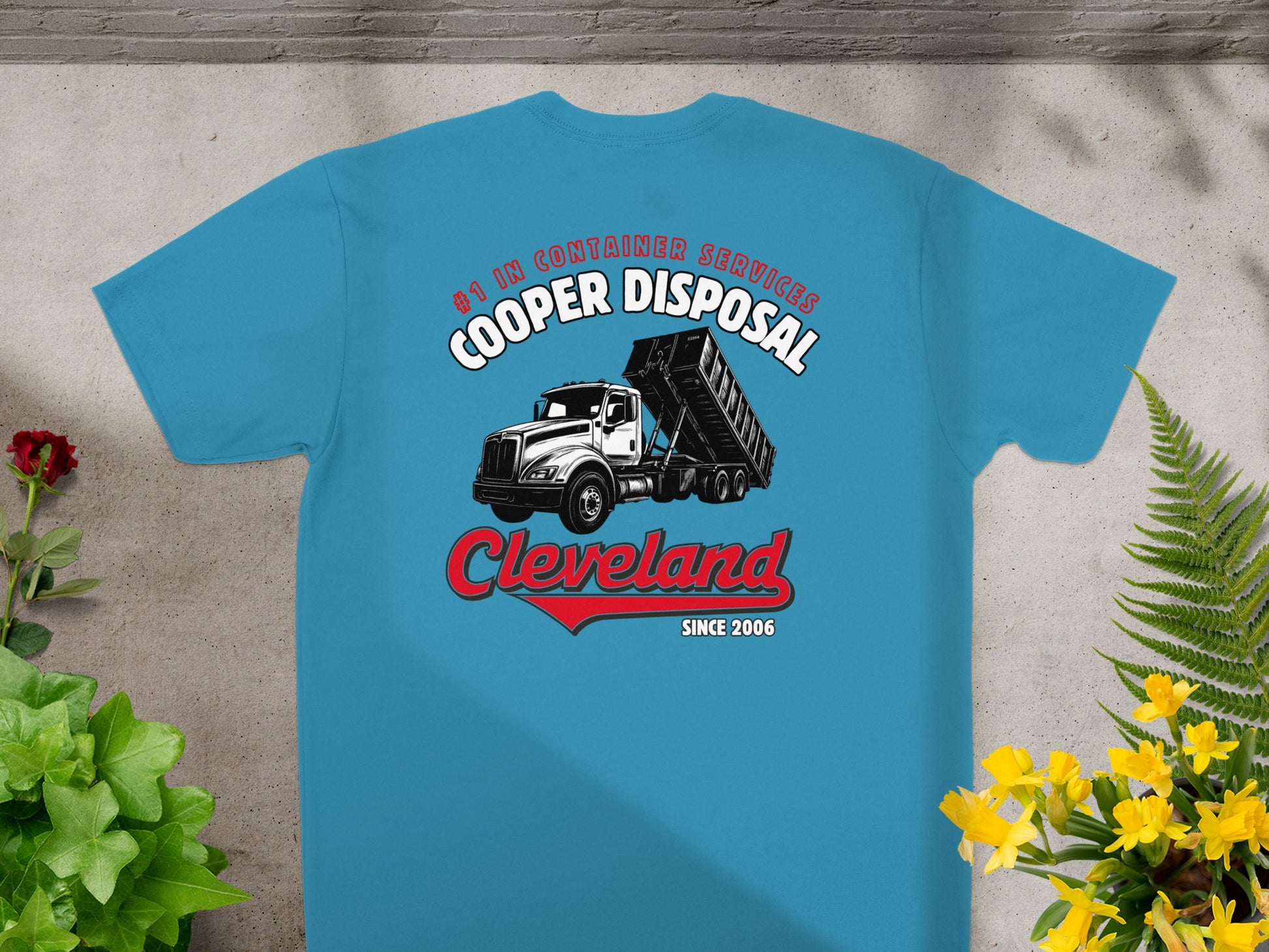 Blue t-shirt with "Cooper Disposal" logo featuring a dumpster truck and red arrow.