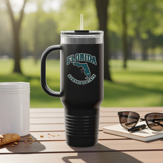 Black travel tumbler with Florida Sunshine State logo, outdoors.