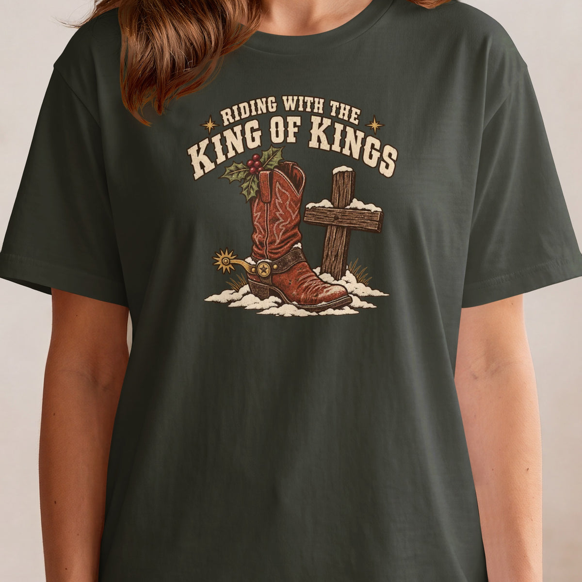 T-shirt graphic with cowboy boot, cross, and text "RIDING WITH THE KING OF KINGS".