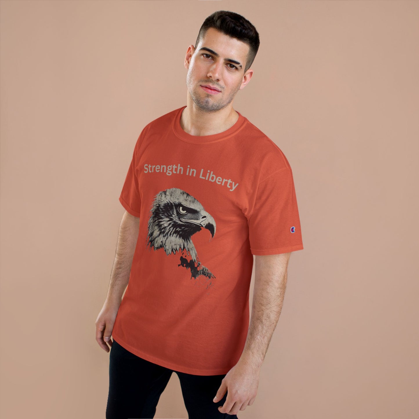 Strength in Liberty text above an eagle head on a Champion Tee