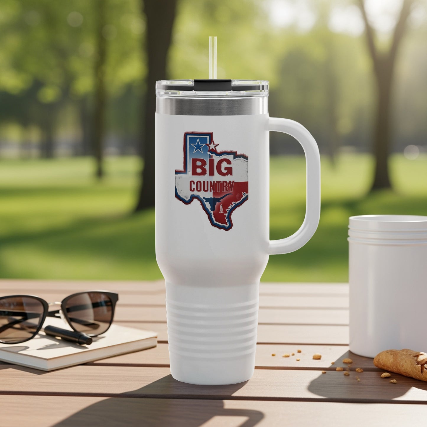 White tumbler with "Big Country" Texas map design on a wooden table.