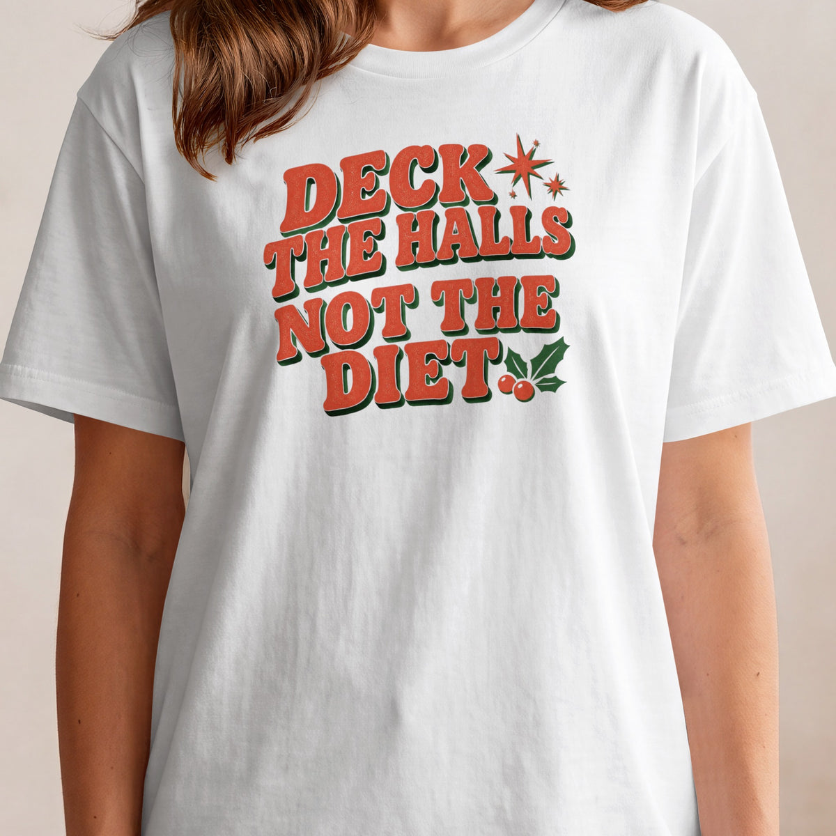 White t-shirt with red and green text that says "Deck the Halls Not The Diet".