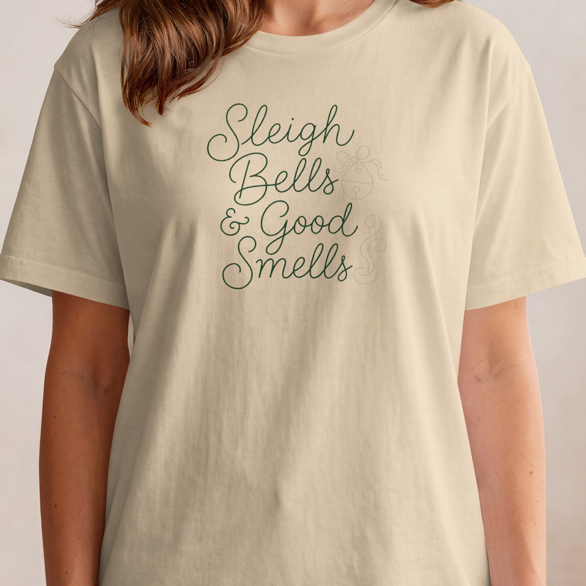 Cream t-shirt with dark green text "Sleigh Bells & Good Smells".