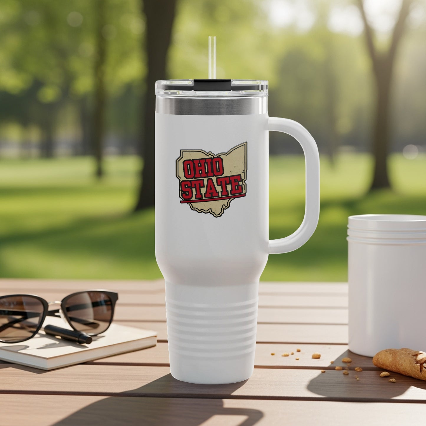 White insulated tumbler with Ohio State logo on a wooden table.