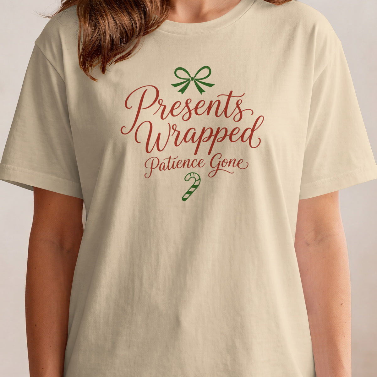 Cream t-shirt with red text "Presents Wrapped, Patience Gone" and green bow and candy cane.