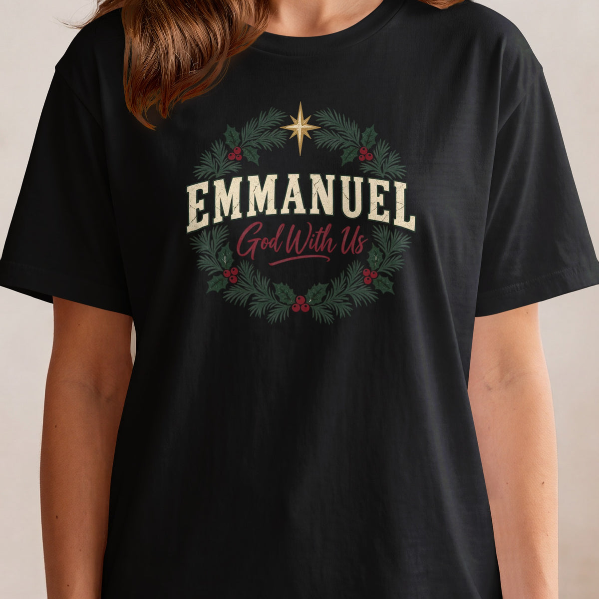 Black t-shirt with "EMMANUEL God With Us" text inside a Christmas wreath.