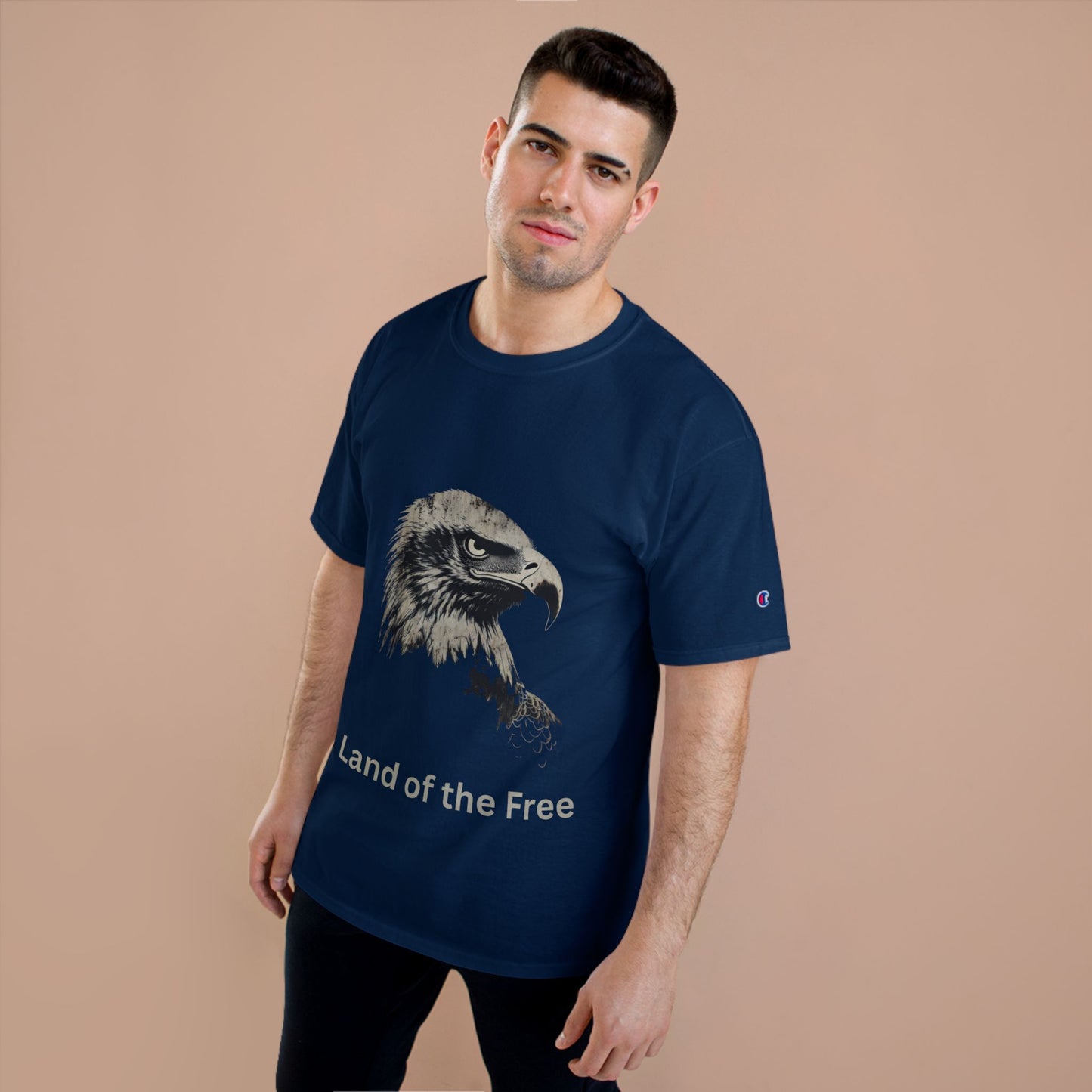 Land of the Free text below an eagle head on a Champion Tee