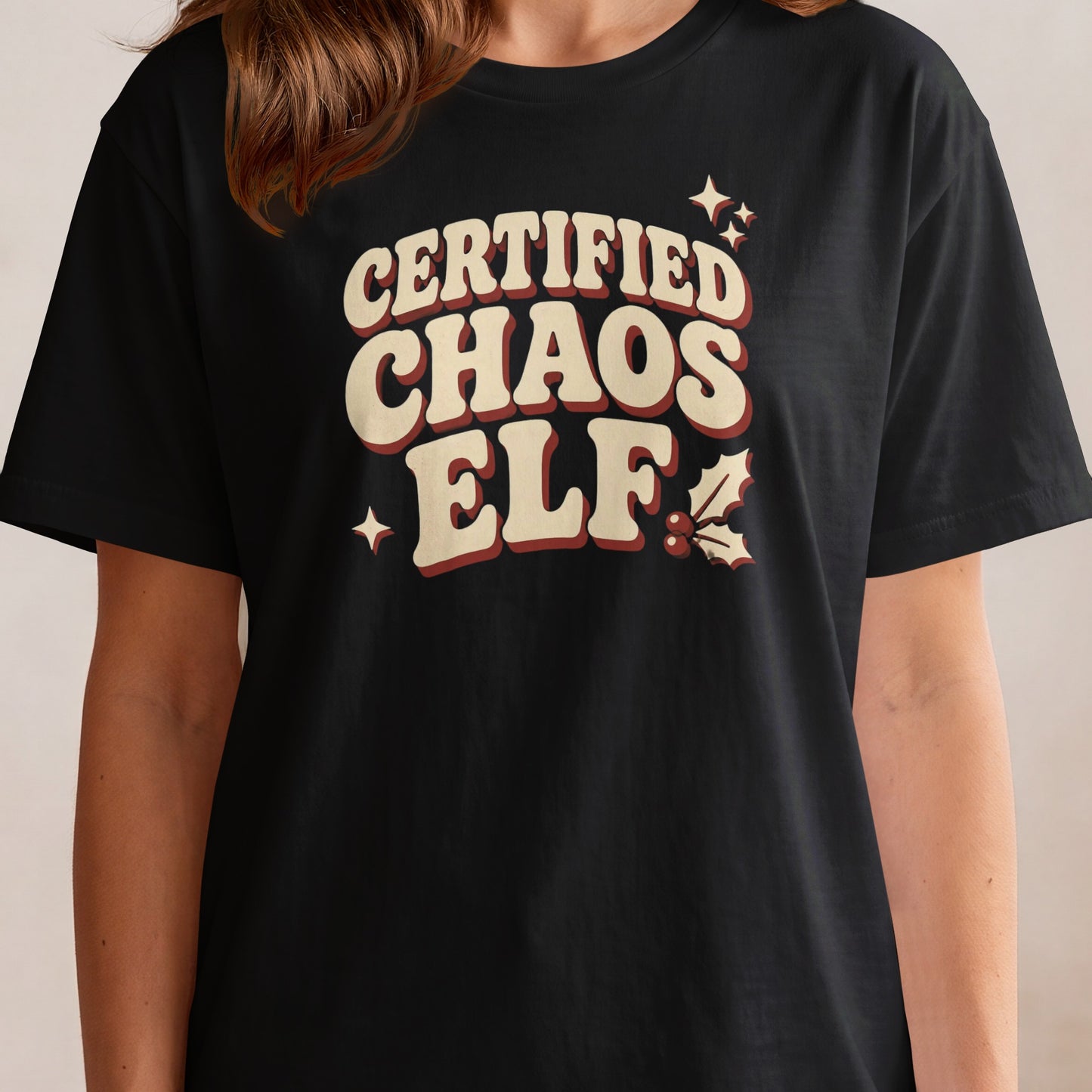 Black t-shirt with "Certified Chaos Elf" text and holiday accents.