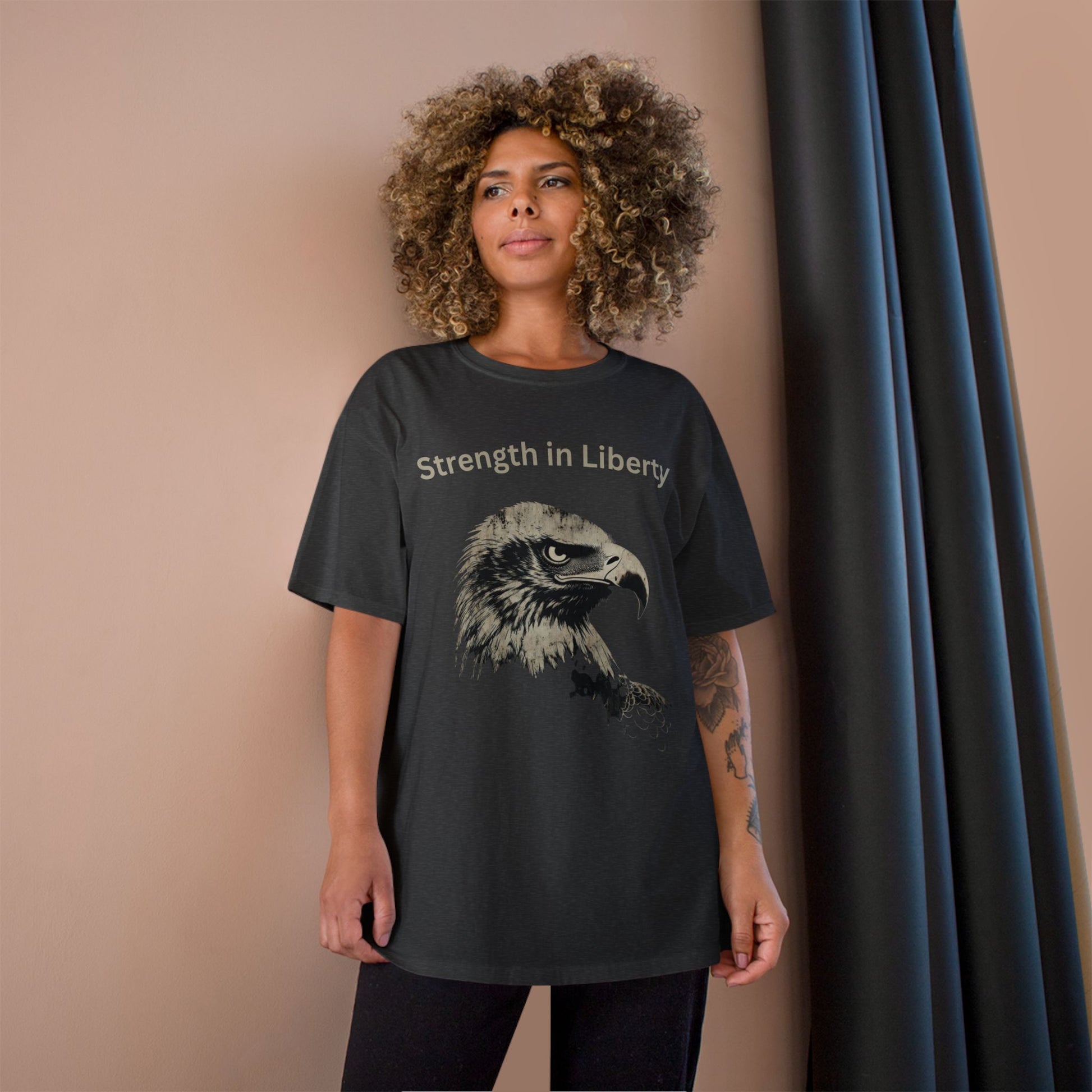 Strength in Liberty text above an eagle head on a Champion Tee