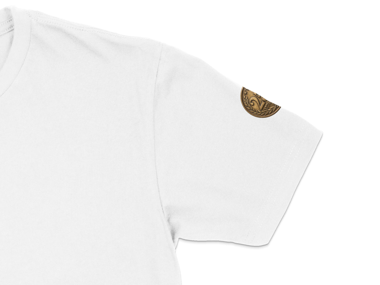 White t-shirt sleeve with a small, round, bronze emblem on the shoulder.
