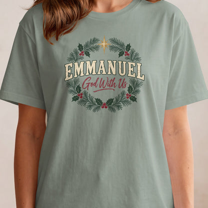 Green t-shirt with white text "EMMANUEL God With Us" inside a Christmas wreath.