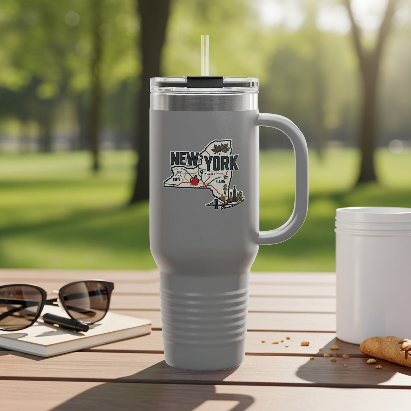 Gray travel mug with a New York State map sticker featuring Buffalo, Syracuse, and Albany.