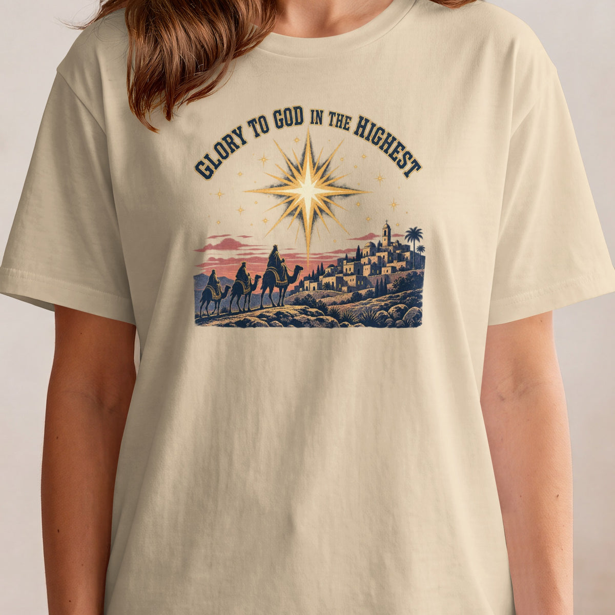 Three kings on camels approach a star-lit town with the text "Glory to God in the Highest."