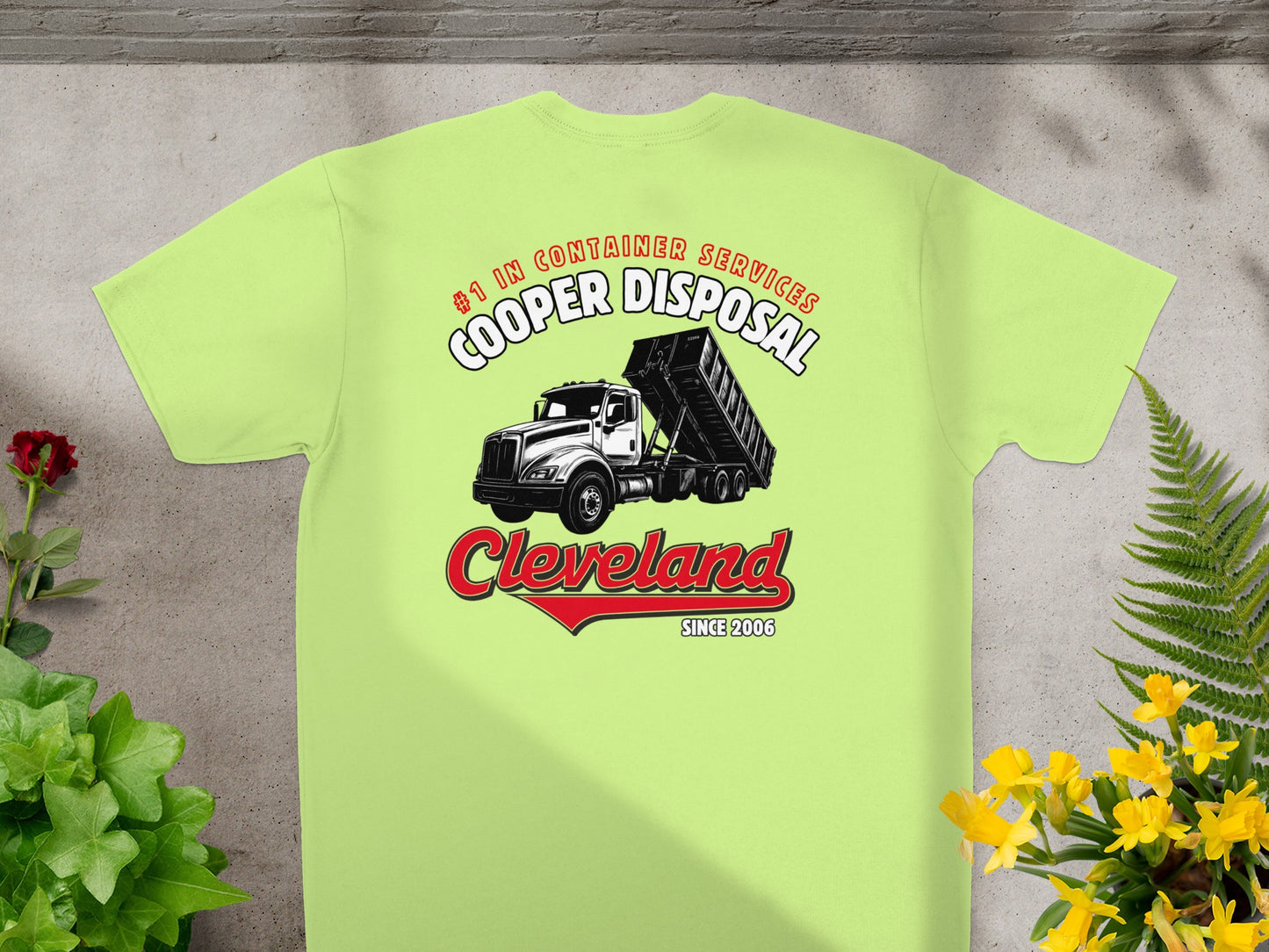 Light green t-shirt featuring a dump truck graphic and "Cooper Disposal Cleveland" text.