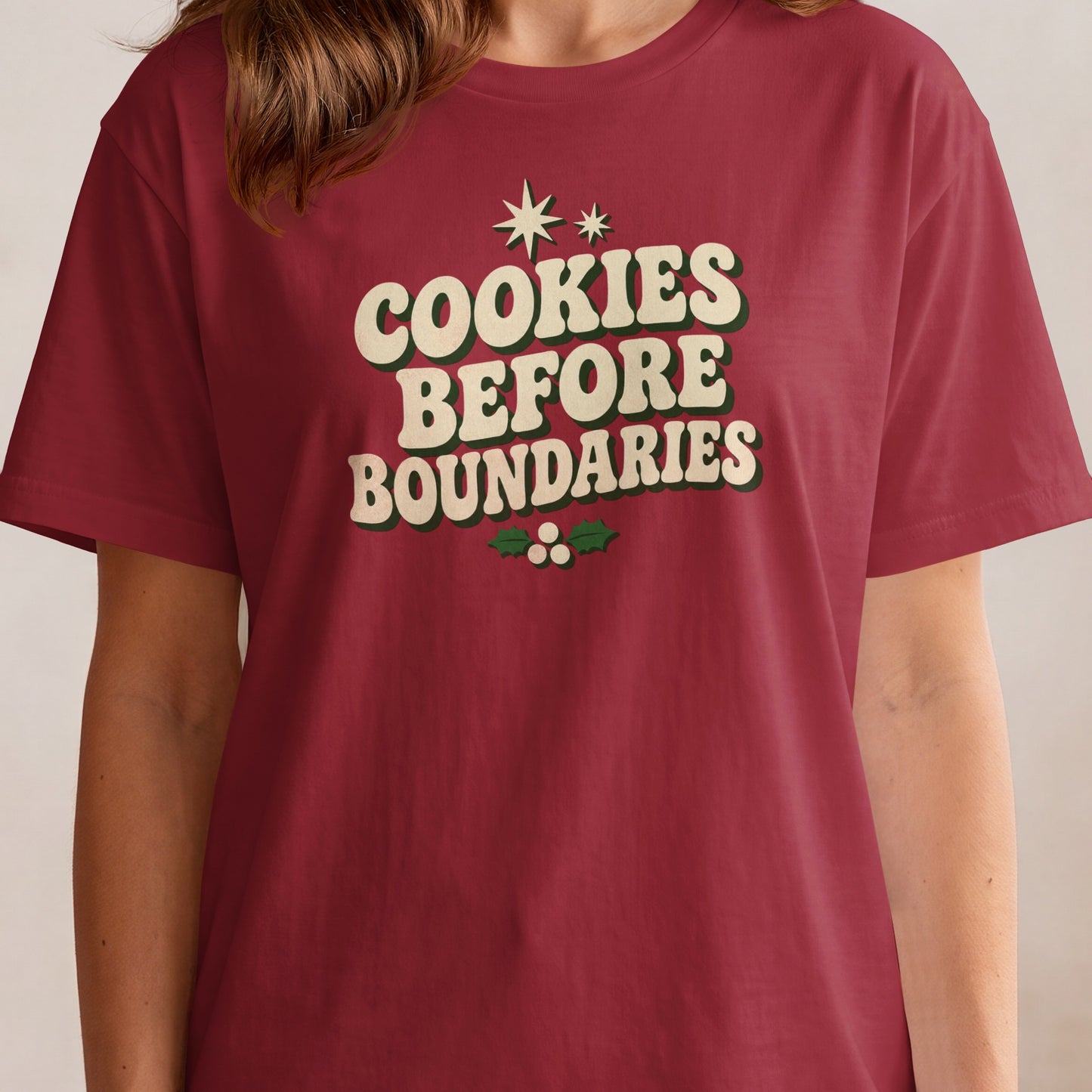 Maroon t-shirt with "COOKIES BEFORE BOUNDARIES" text and holly graphic.