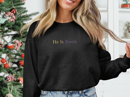 Black sweatshirt with "He Is Risen" text on the chest.