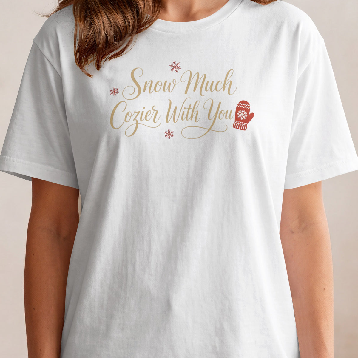 White t-shirt with "Snow Much Cozier With You" text and holiday graphics.