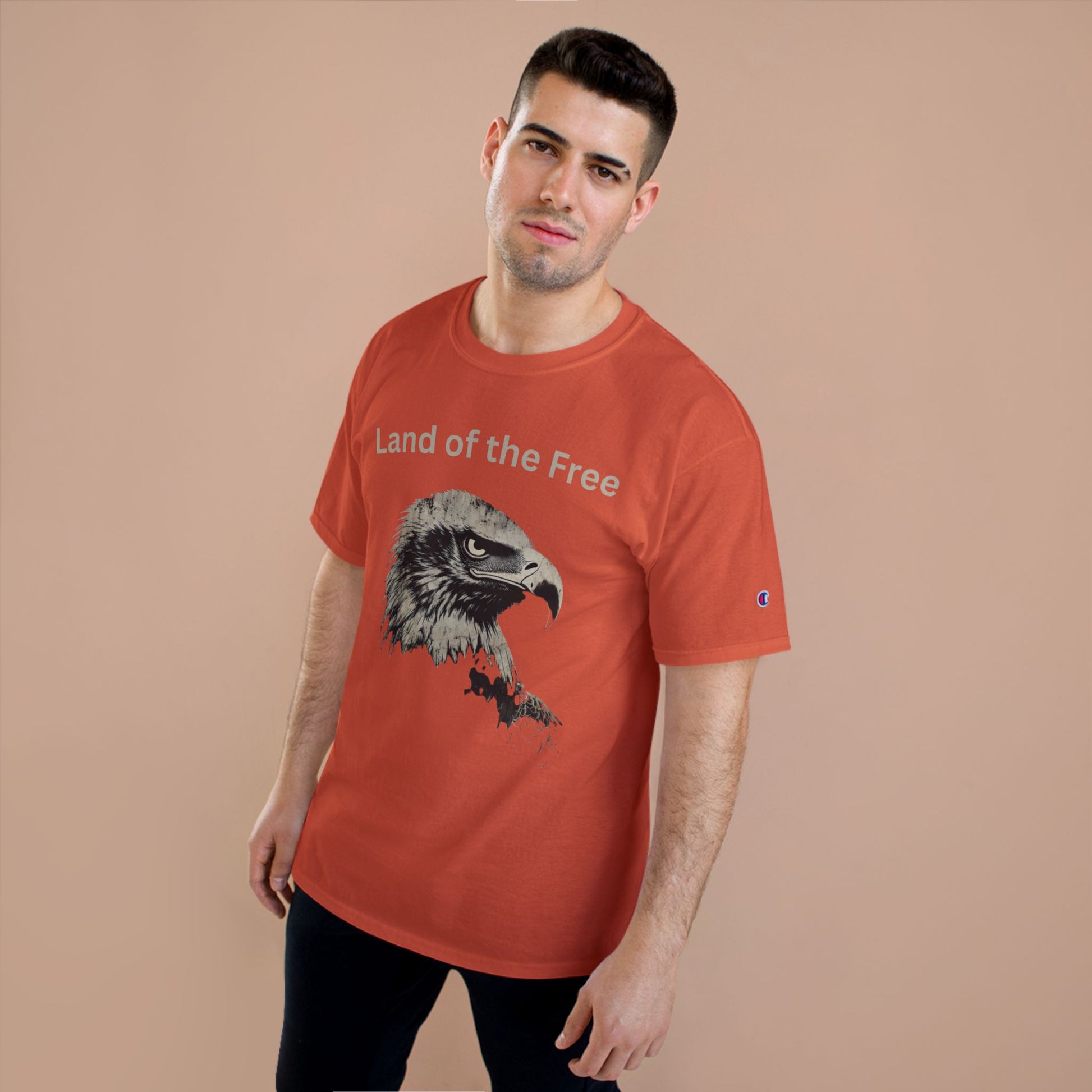 Land of the Free text above an eagle head on a Champion Tee