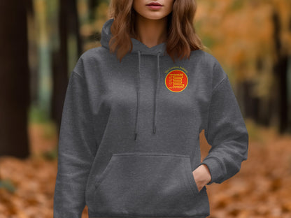 Dark gray hoodie with circular logo featuring text and red and yellow design elements.