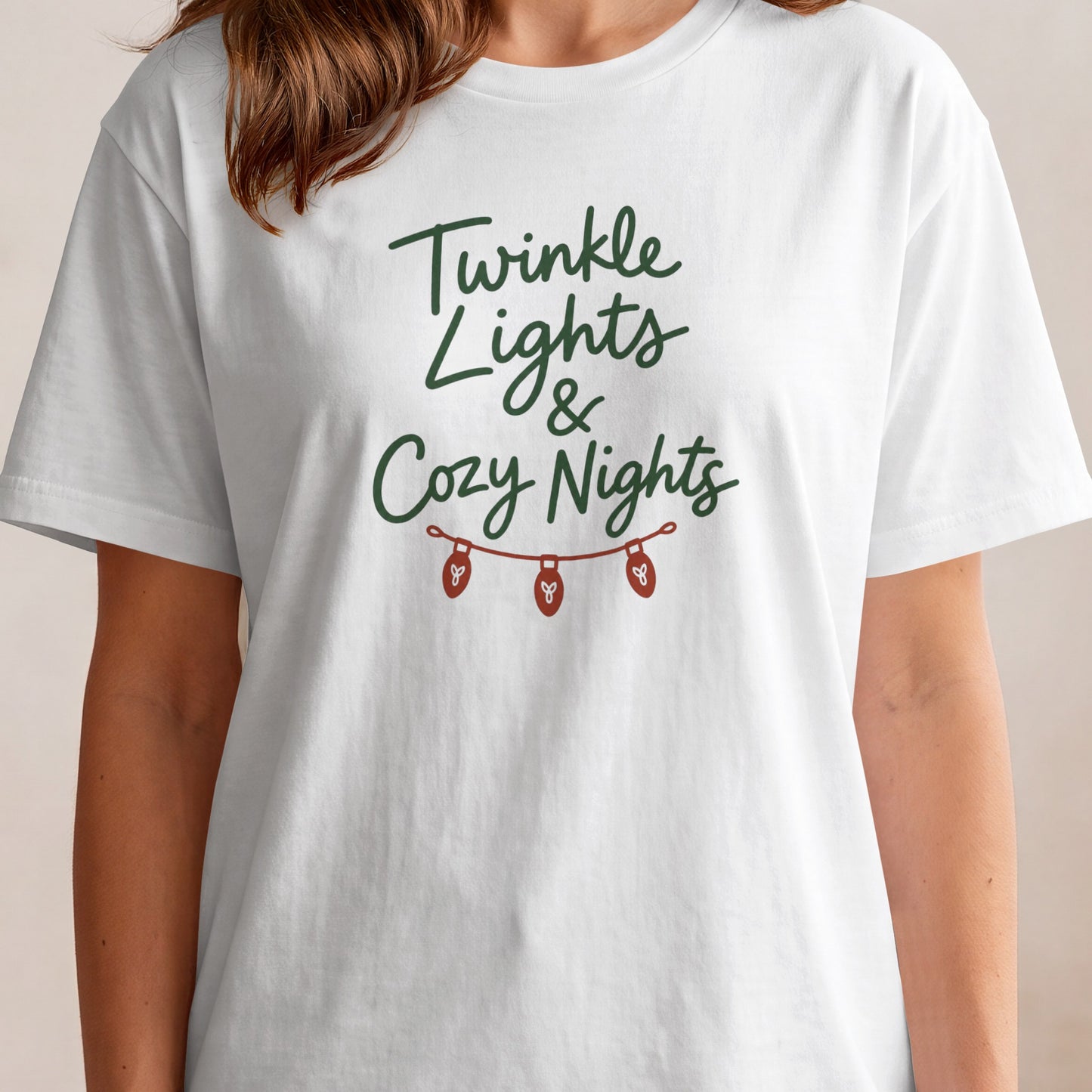 White t-shirt with "Twinkle Lights & Cozy Nights" and a string of lights graphic.