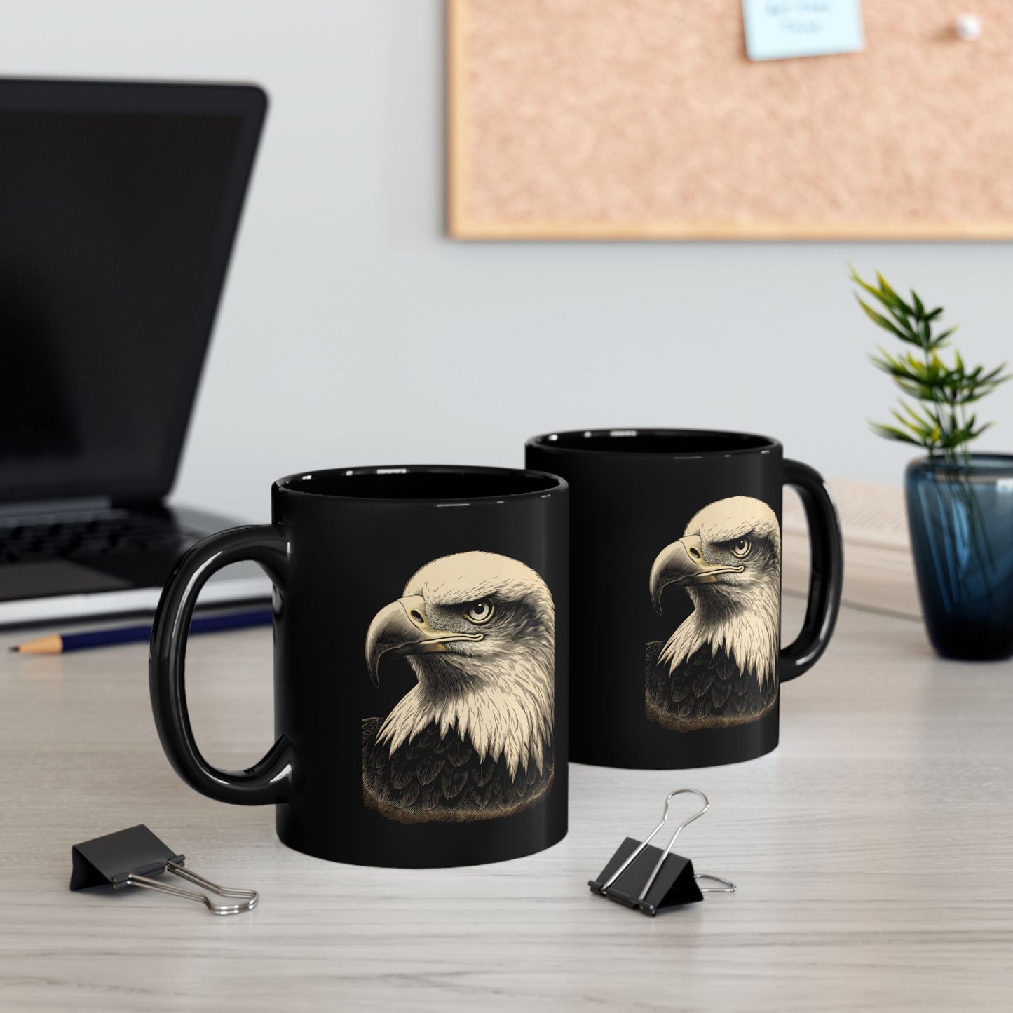 Two black mugs featuring the detailed head of a bald eagle.