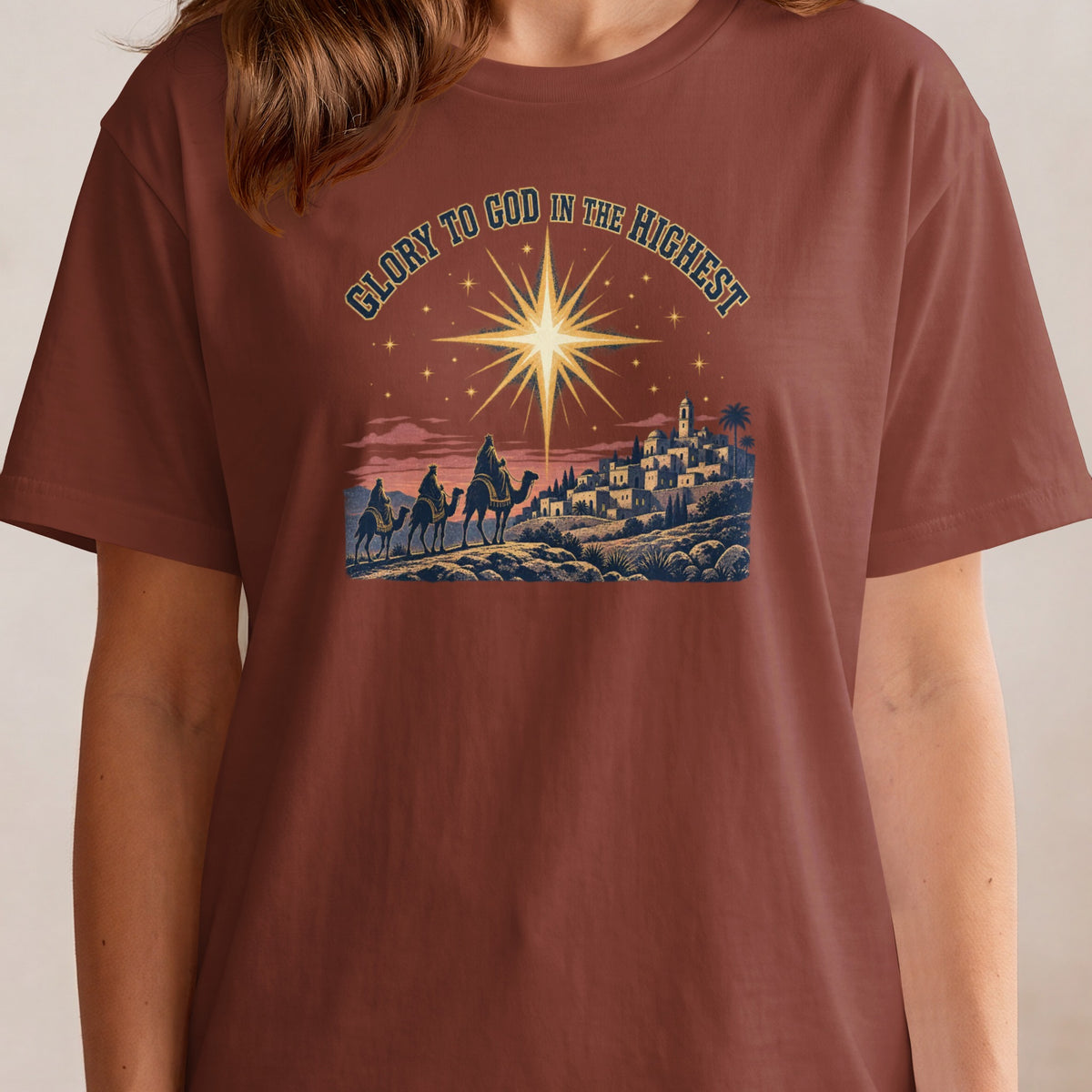 Three Wise Men on camels approach a village under the Star of Bethlehem.