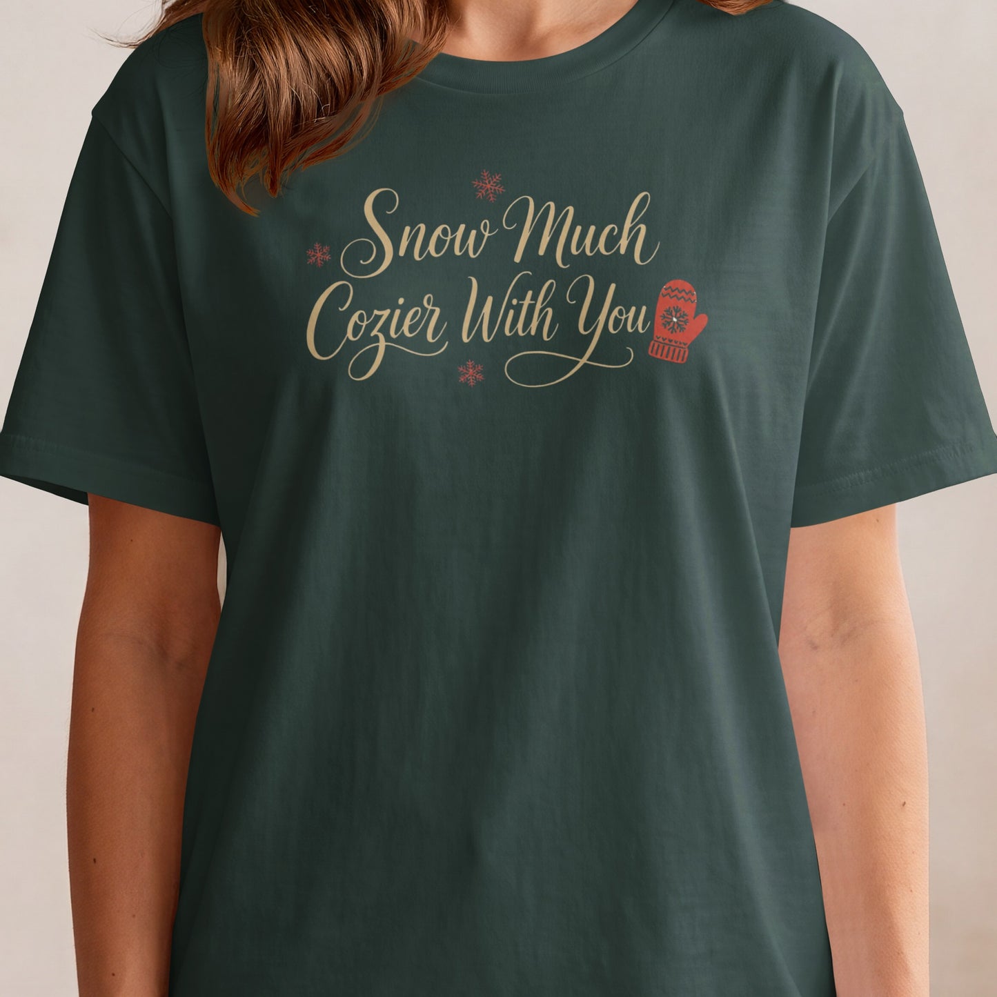 Dark green t-shirt with "Snow Much Cozier With You" text and a mitten graphic.