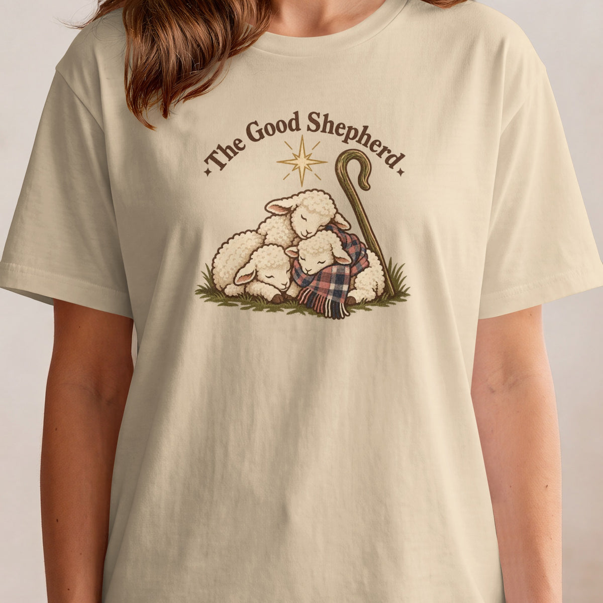 Three sleeping sheep huddle together under a plaid scarf and shepherd's crook.