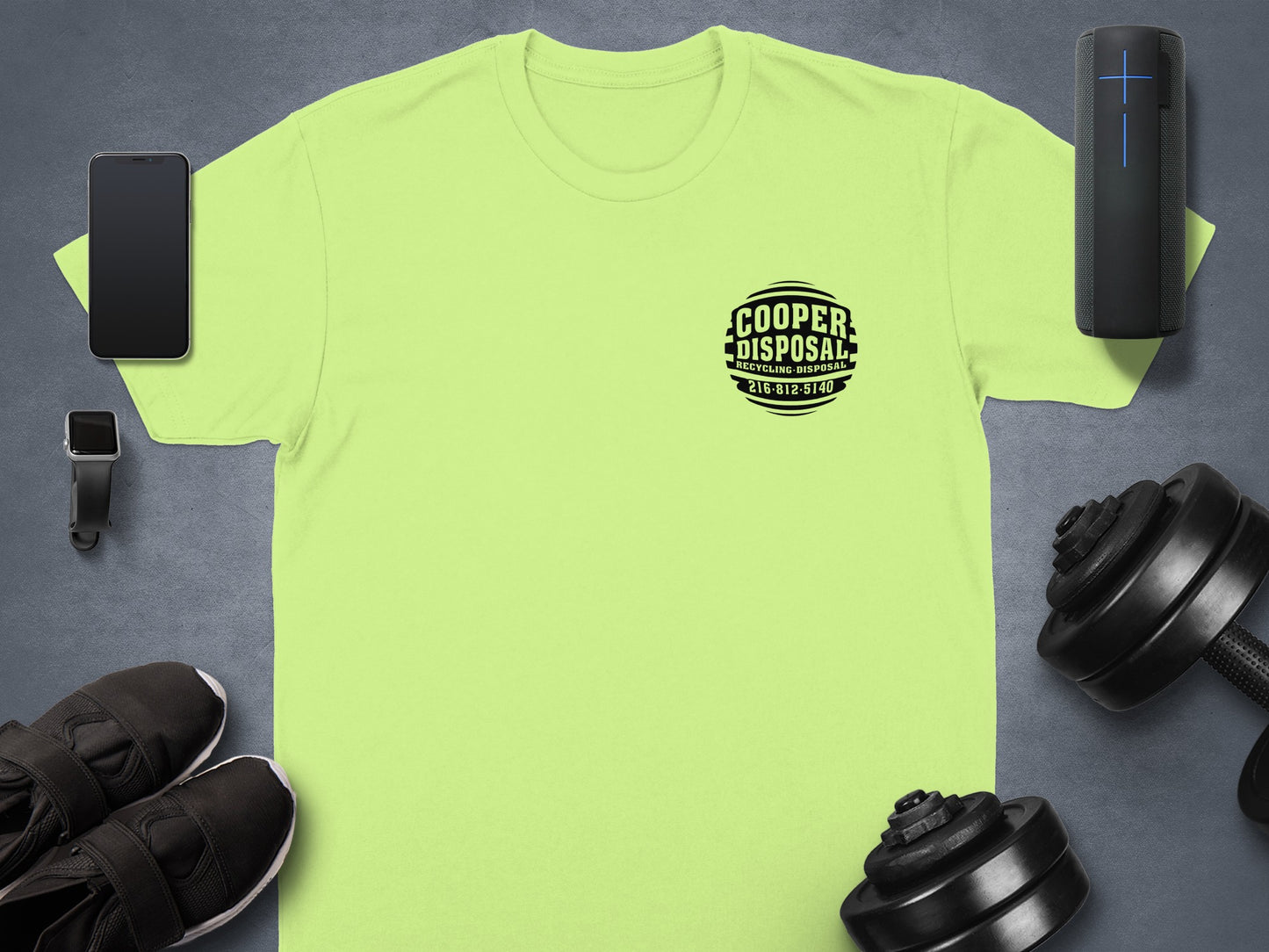 Lime green t-shirt with "Cooper Disposal" logo, surrounded by workout gear.