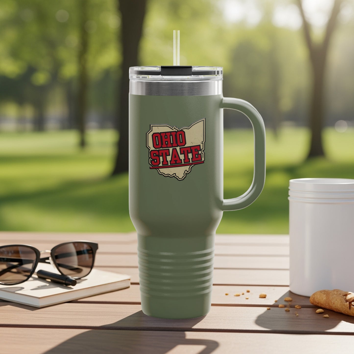 Olive green tumbler with Ohio State logo sits on a table.