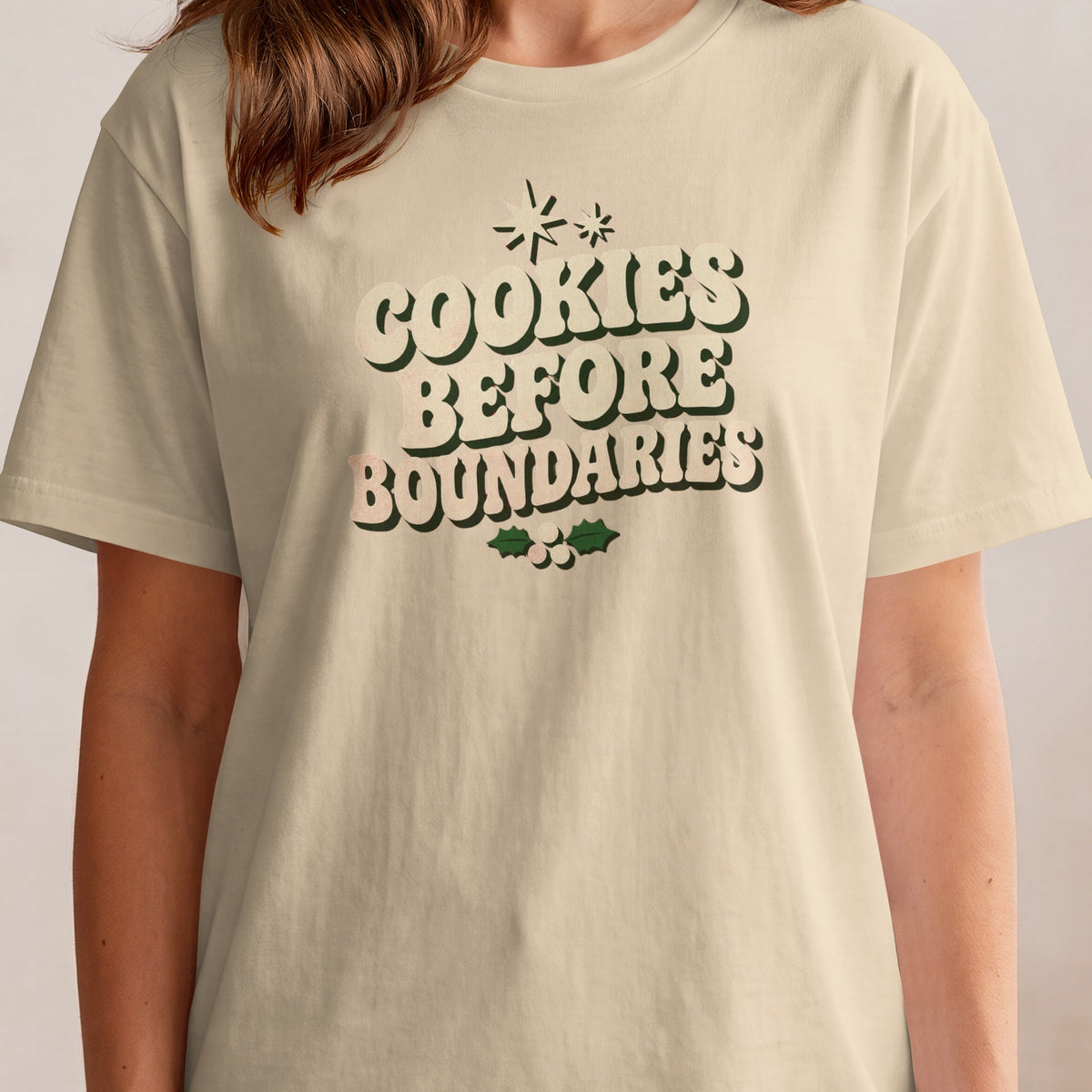 Light beige t-shirt with "Cookies Before Boundaries" text and holly graphic.