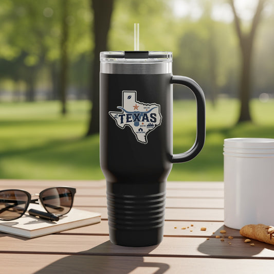 Black travel mug with Texas outline logo and handle, on outdoor table.