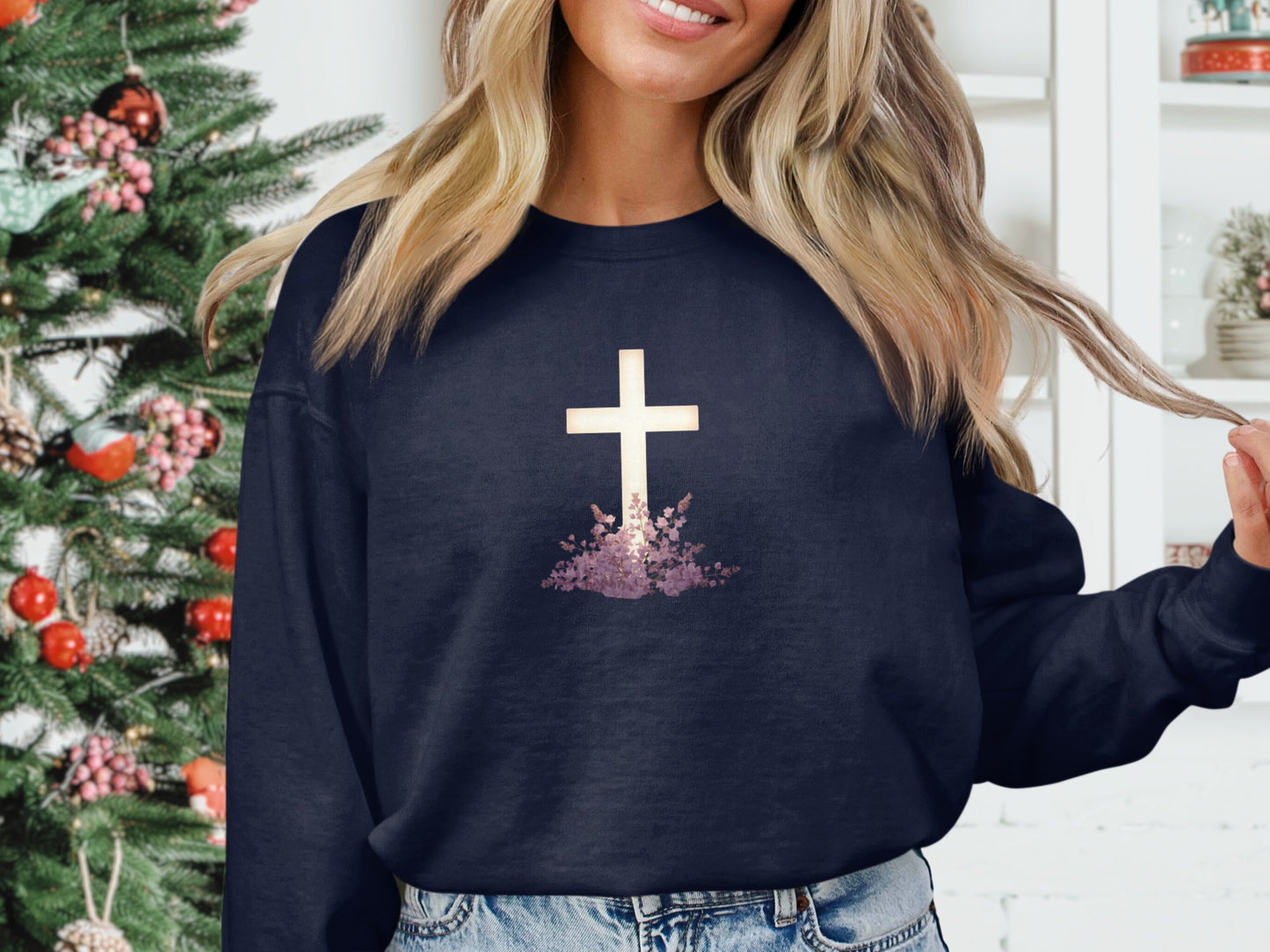 Navy sweatshirt with white cross and floral design.