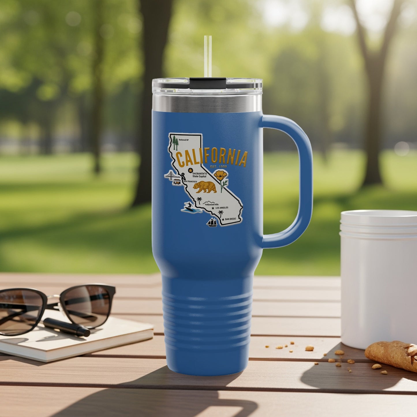 Blue travel tumbler with California map and cities illustration.