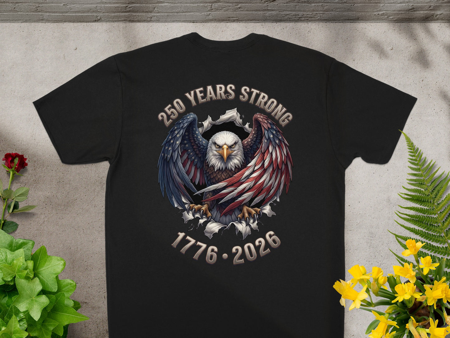 Black t-shirt featuring an eagle with wings spread, bearing "250 YEARS STRONG 1776-2026" text.