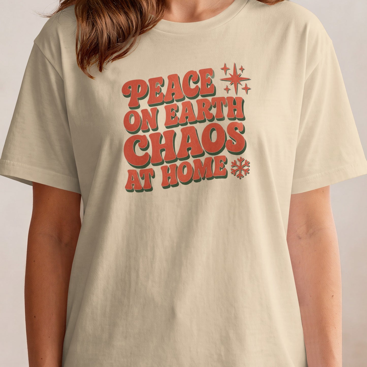Cream t-shirt with "Peace on Earth Chaos at Home" text and festive stars.