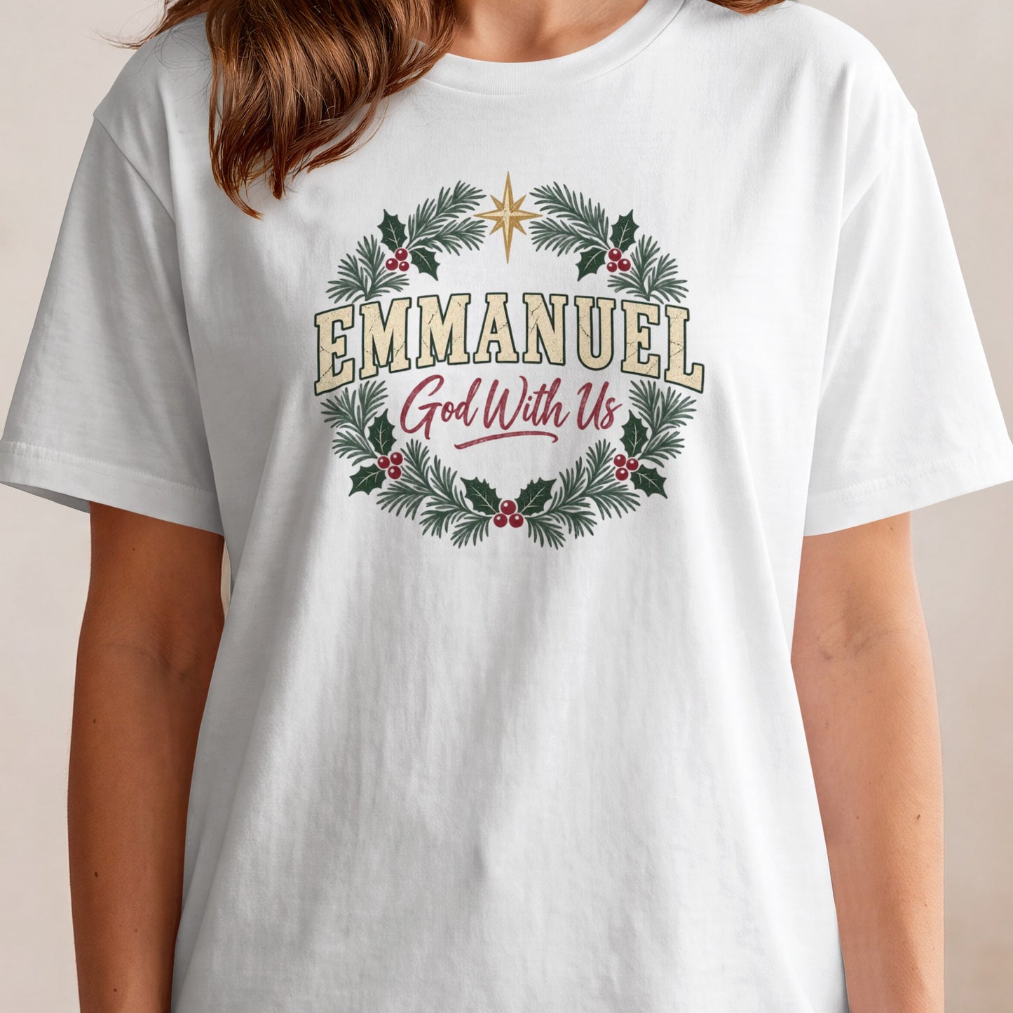 White t-shirt with a Christmas wreath graphic and text "Emmanuel God With Us".
