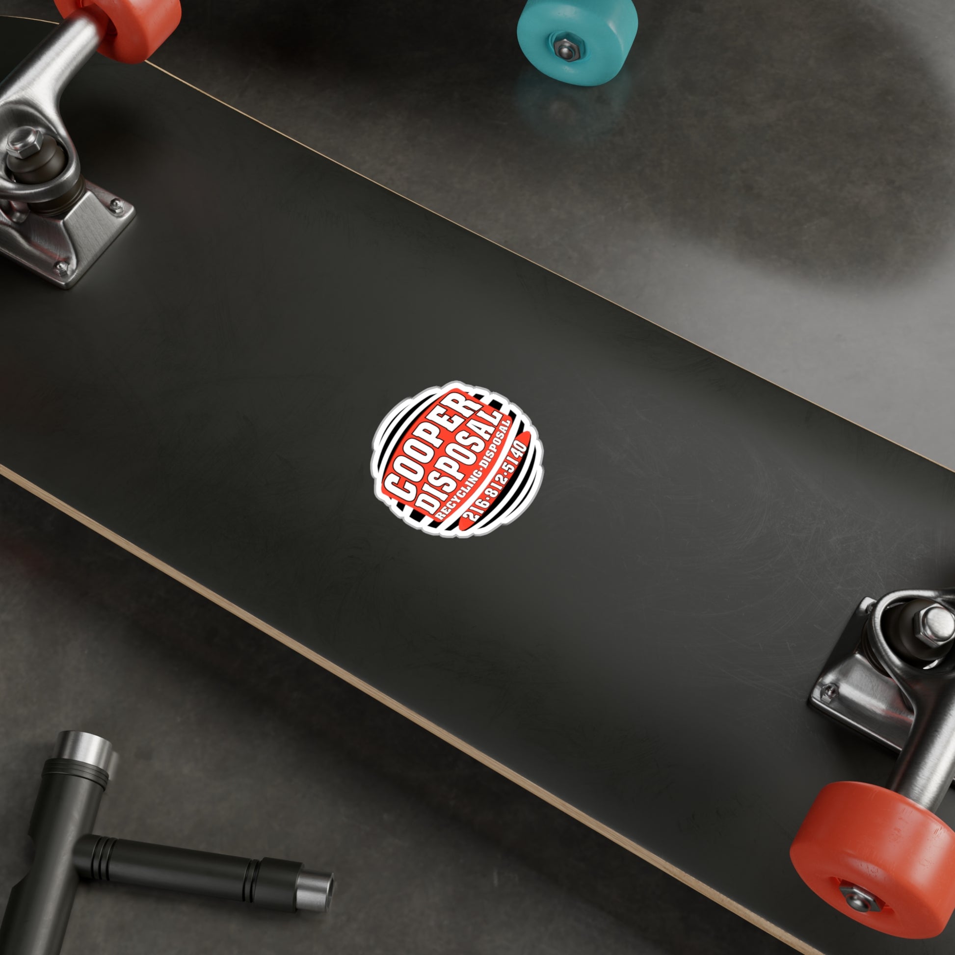 Cooper Disposal decal with contact information on a skateboard.
