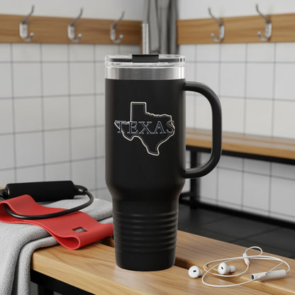 Black tumbler with Texas outline, handle, and straw, on wooden bench.